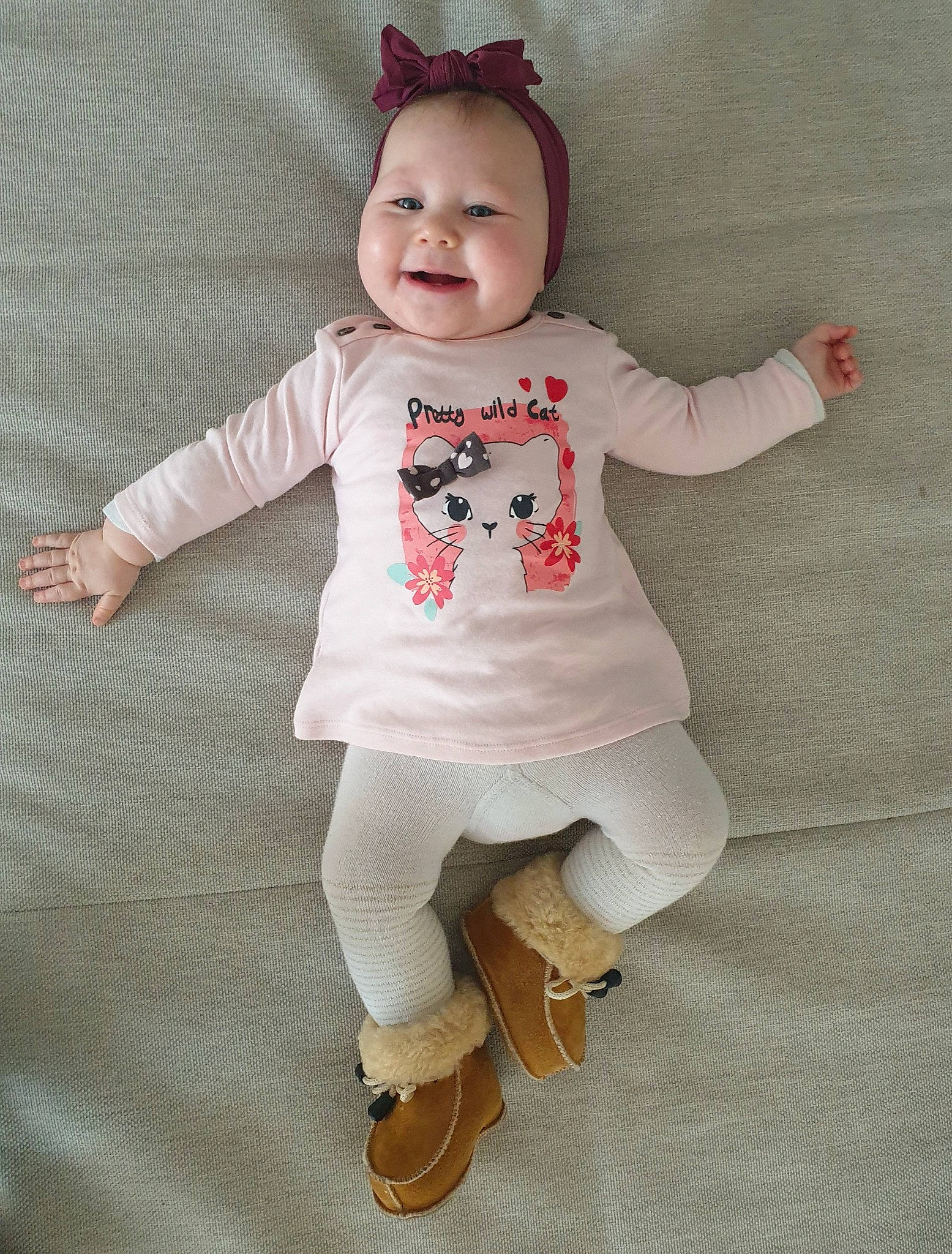 Riley a rejoint le concours — aidez-le/la à gagner de superbes lots ! baby, baby_toddler_clothing, child, costume_hat, face, footwear, happy, head, joy, outerwear, pattern, person, pink, skin, sleeve, smile, sock, textile, toddler, toy