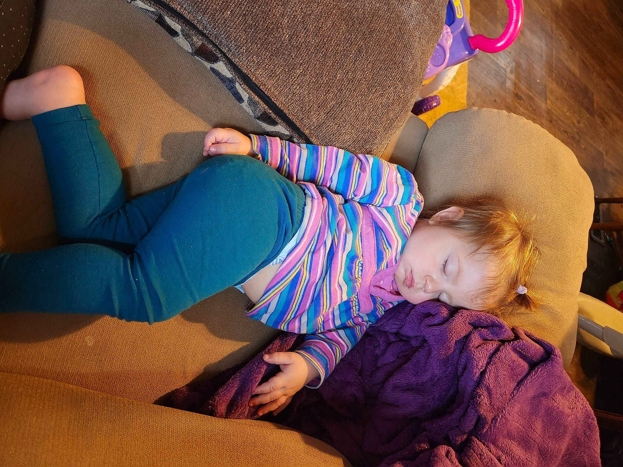 Madeline is registered to the contest to win money with this photo: arm, comfort, elbow, electric_blue, flooring, fun, happy, human_leg, joint, knee, lap, leg, leisure, orange, person, sock, sportswear, thigh, trunk, waist