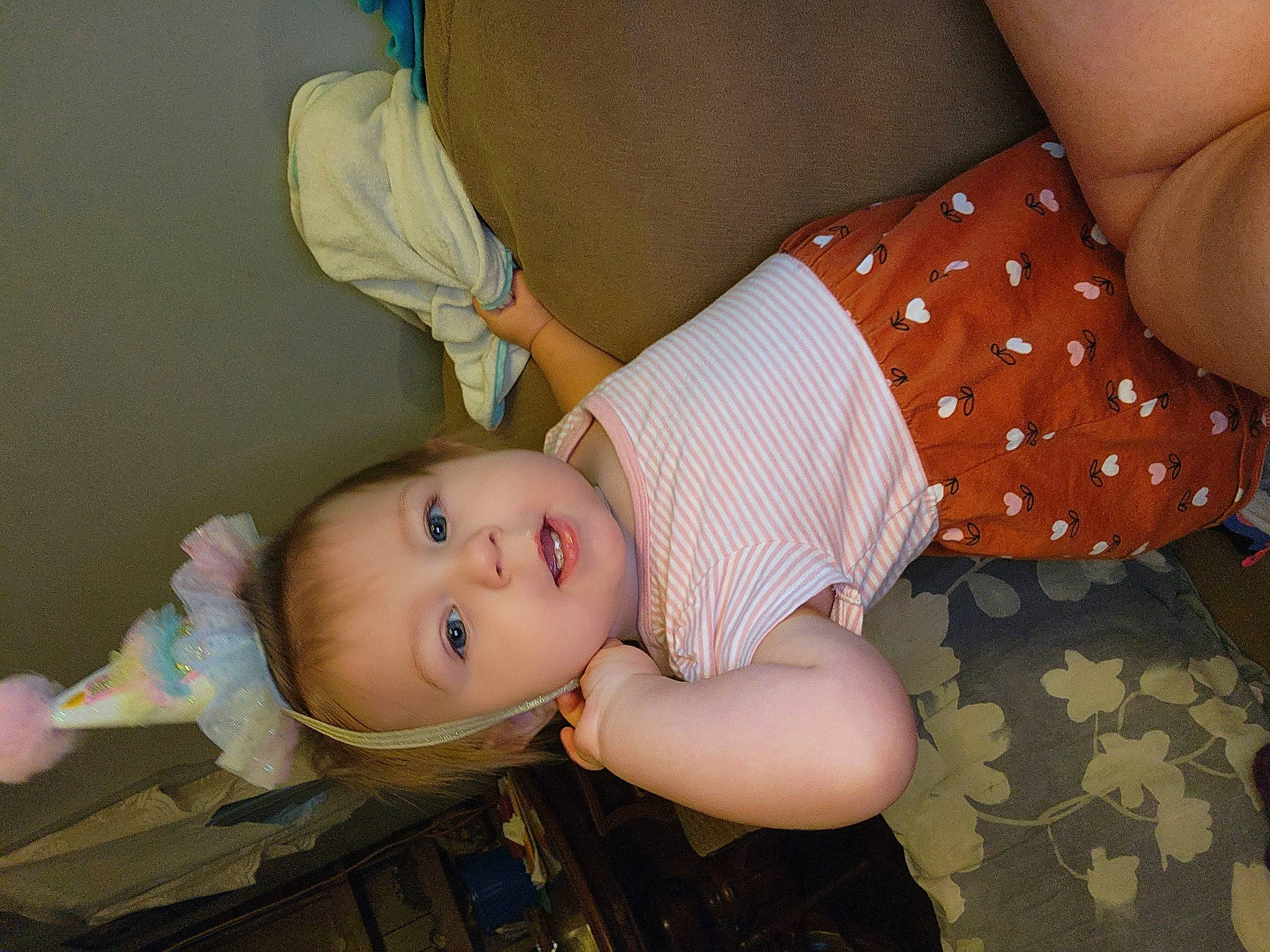 Madeline is registered to the contest to win money with this photo: abdomen, arm, baby, baby_products, baby_toddler_clothing, chest, child, comfort, elbow, happy, human_leg, joint, pattern, person, room, skin, thigh, toddler, toy, trunk