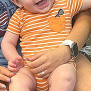 Echo joined the competition — help win amazing prizes! baby, child, smile, happy, infant, onesie, orange_stripes, person, hand, watch, ring, skin, legs, feet, sitting, holding, joy, cute, casual, indoor