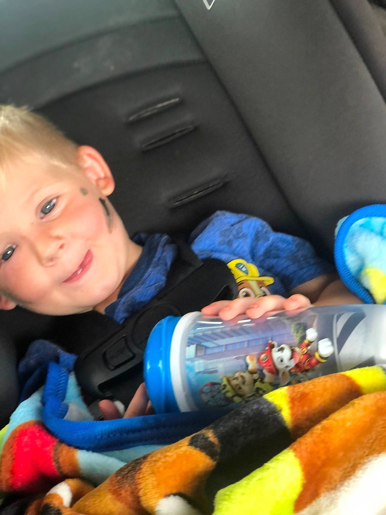 Blayke is registered to the contest to win money with this photo: auto_part, blue, car_seat, car_seat_cover, child, comfort, electric_blue, finger, fun, head_restraint, joy, lap, mouth, nail, person, product, smile, steering_wheel, thumb, toddler