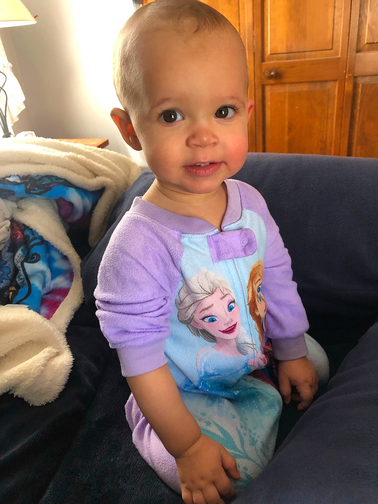 Braelyn is registered to the contest to win money with this photo: baby, baby_toddler_clothing, cheek, child, comfort, eye, face, fun, happy, head, human_body, mammal, mouth, nose, person, product, purple, skin, sleeve, smile