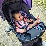 Maxyne is registered to the contest to win money with this photo: baby, casual, child, cute, daylight, foot, footwear, grass, happy, infant, outdoor, path, person, playful, purple, seatbelt, shoe, stroller, summer