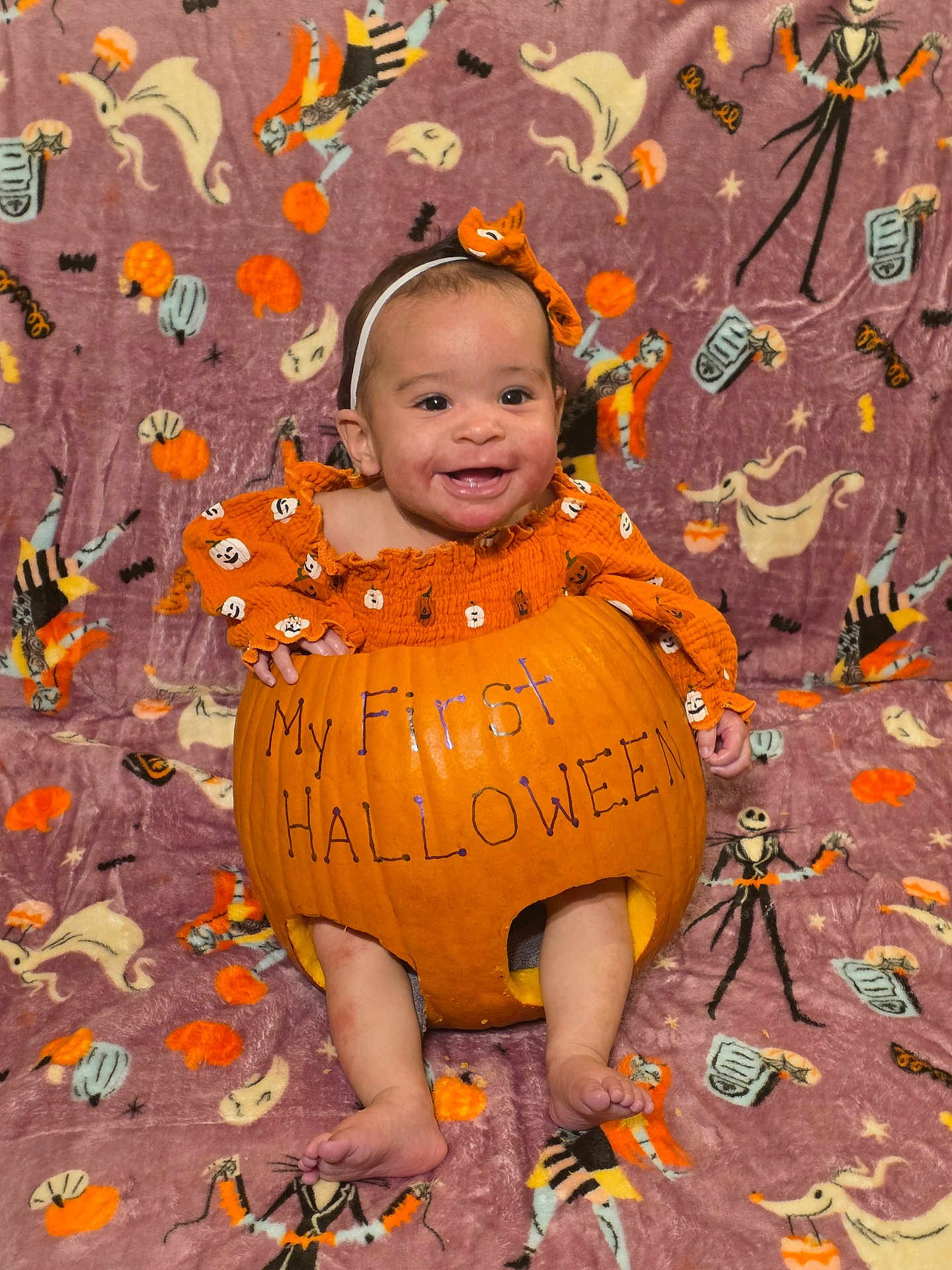 Maxyne is registered to the contest to win money with this photo: baby, pumpkin, halloween, orange_clothing, headband, smiling, holiday, blanket, ghost, skeleton, costume, infant, cute, celebration, festive, autumn, child, portrait, happy, seasonal