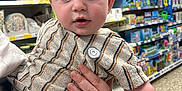 Luca is registered to the contest to win money with this photo: baby, child, person, striped_clothing, hand, store, aisle, shelves, toys, products, shopping, indoor, curious, blonde_hair, blue_eyes, portrait, casual, holding, retail, floor