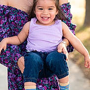 Merellio joined the competition — help win amazing prizes! toddler, child, smiling, happy, person, adult, holding, purple_top, blue_jeans, colorful_socks, outdoor, sunlight, floral_dress, portrait, cute, joyful, casual_clothing, nature, family, playful