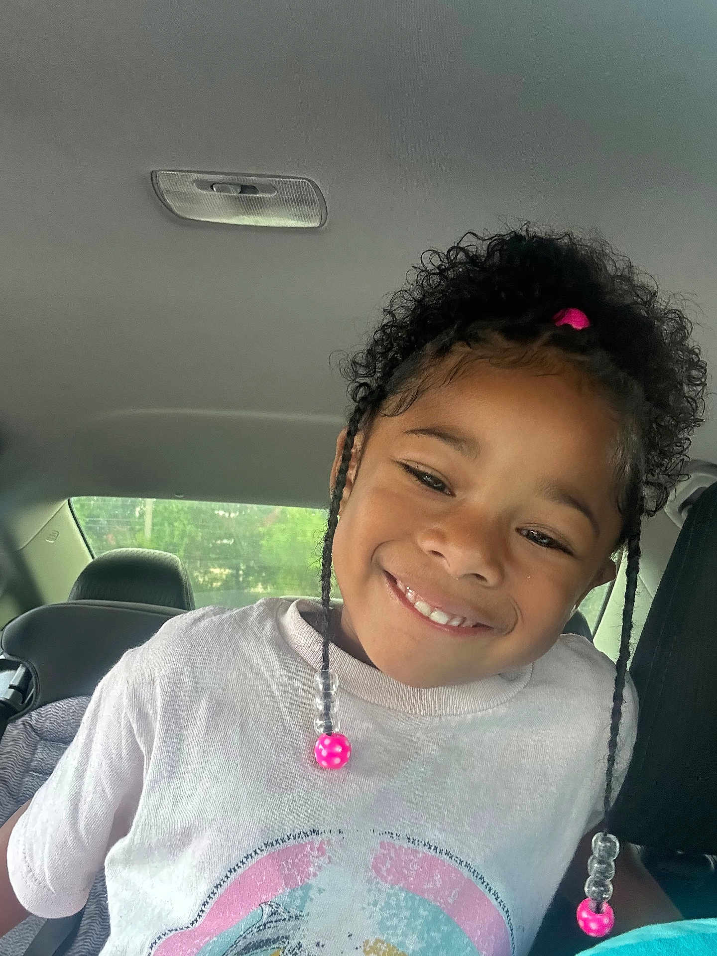 Autumn joined the competition — help win amazing prizes! child, smile, curly_hair, beads, tshirt, car_interior, seat, window, natural_light, portrait, happy, person, face, hair_accessory, casual_clothing, young, cute, indoors, seatbelt, head