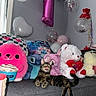 Chanel Vasquez is registered to the contest to win money with this photo: balloon, cat, celebration, colorful, couch, cute, decor, funny, gray_couch, heart_shaped_balloon, indoor, pillow, pink_balloon, plush_toy, relaxed, soft_toy, stuffed_animal, tabby, tongue_out, white_bear
