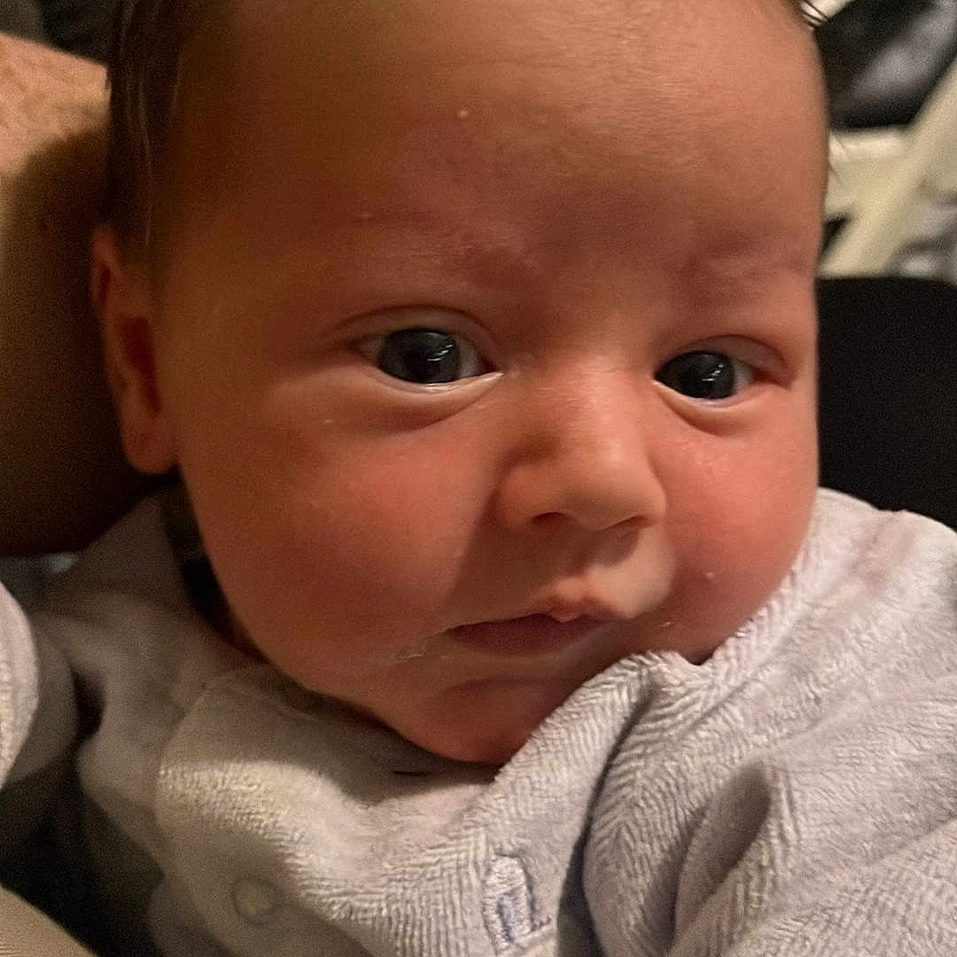 Scott is registered to the contest to win money with this photo: baby, blanket, clothing, couch, cushion, face, furniture, happy, head, homedecor, knitwear, laughing, linen, newborn, person, photography, portrait, quilt, smile, sweater