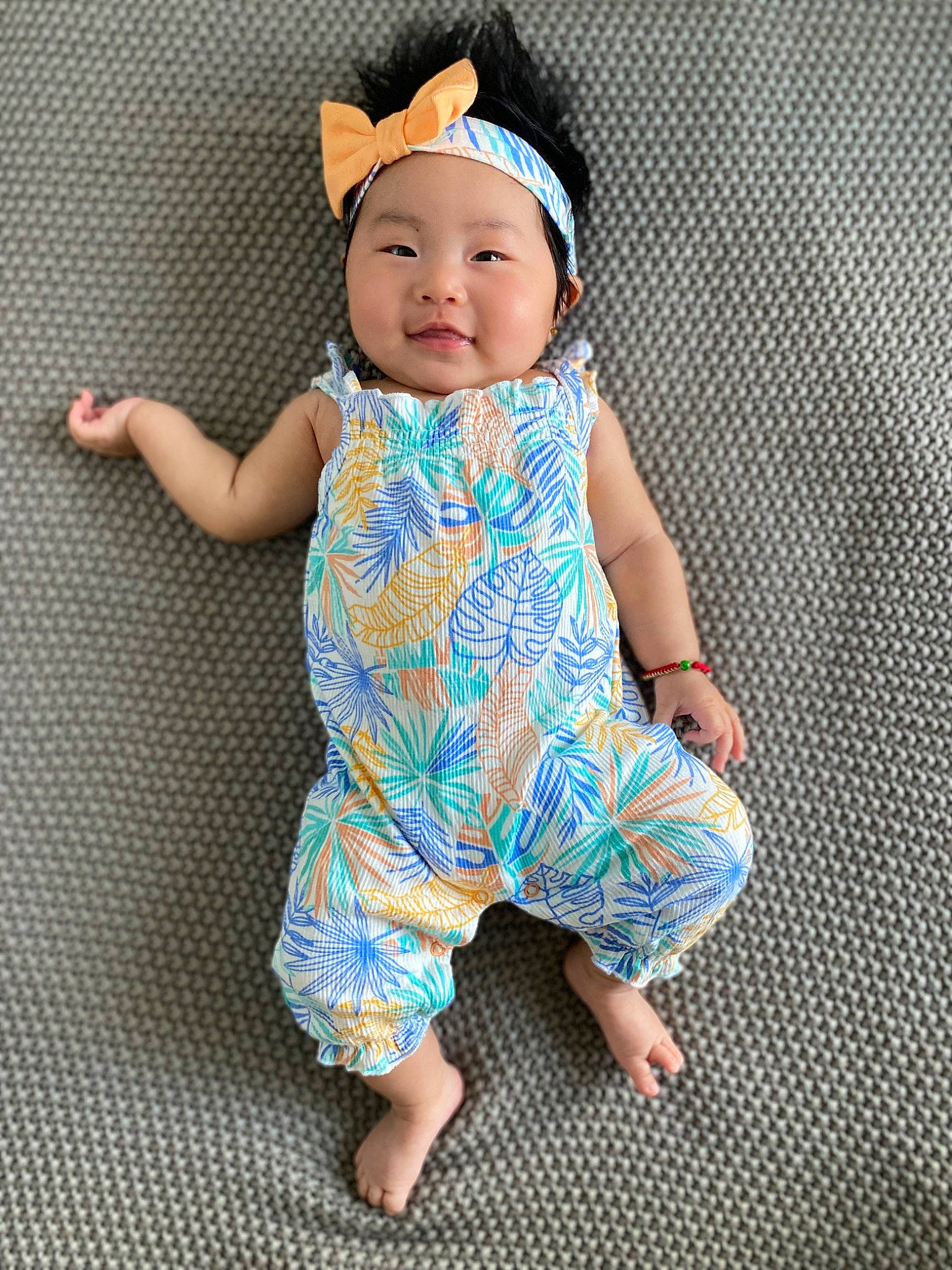 Mia is registered to the contest to win money with this photo: baby, baby_toddler_clothing, cap, child, collar, day_dress, dress, face, fashion_accessory, happy, hat, head, headwear, one_piece_garment, pattern, person, product, sleeve, smile, t_shirt