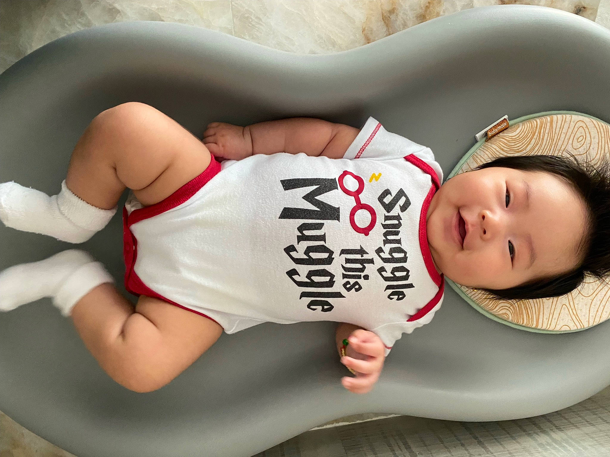 Mia is registered to the contest to win money with this photo: arm, black_hair, chest, comfort, elbow, facial_expression, finger, human_body, joint, knee, leg, mouth, muscle, neck, organ, person, sleeve, thigh, trunk, waist