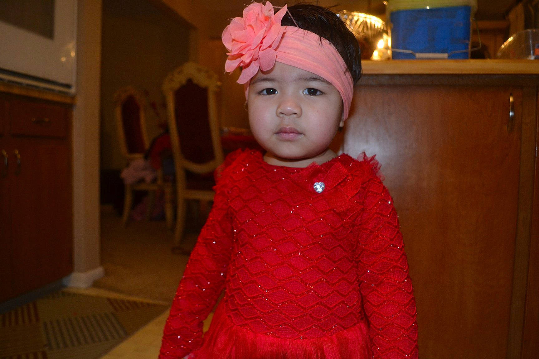 Penelope Andreas joined the competition — help win amazing prizes! baby, cheek, child, costume, dress, eye, face, hair_accessory, head, headgear, headpiece, headwear, outerwear, person, pink, red, standing, toddler