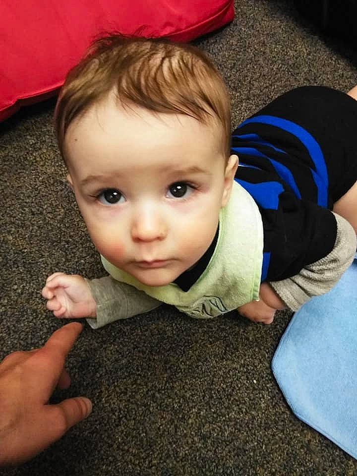 Wayne is registered to the contest to win money with this photo: boy, cheek, child, chin, ear, eye, face, finger, forehead, hair, hairstyle, hand, head, human_hair_color, infant, mouth, nose, person, sitting, skin