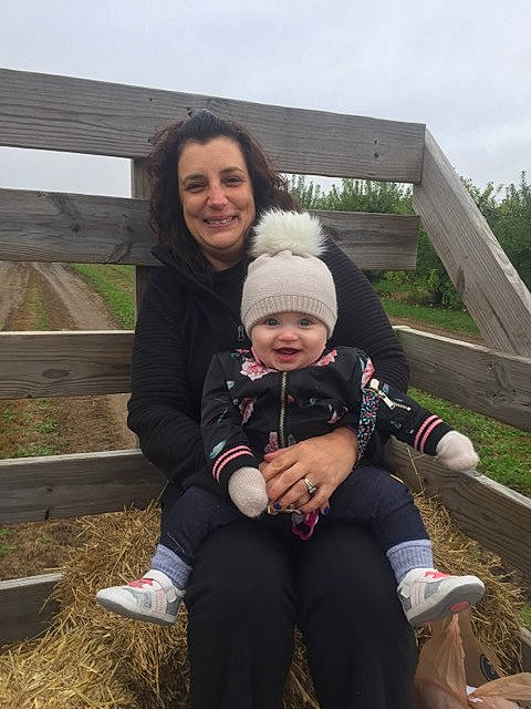 Paislee is registered to the contest to win money with this photo: car, child, day, family, fun, grass, headgear, headwear, joy, people, person, plant, product, recreation, smile, tree, vacation, winter