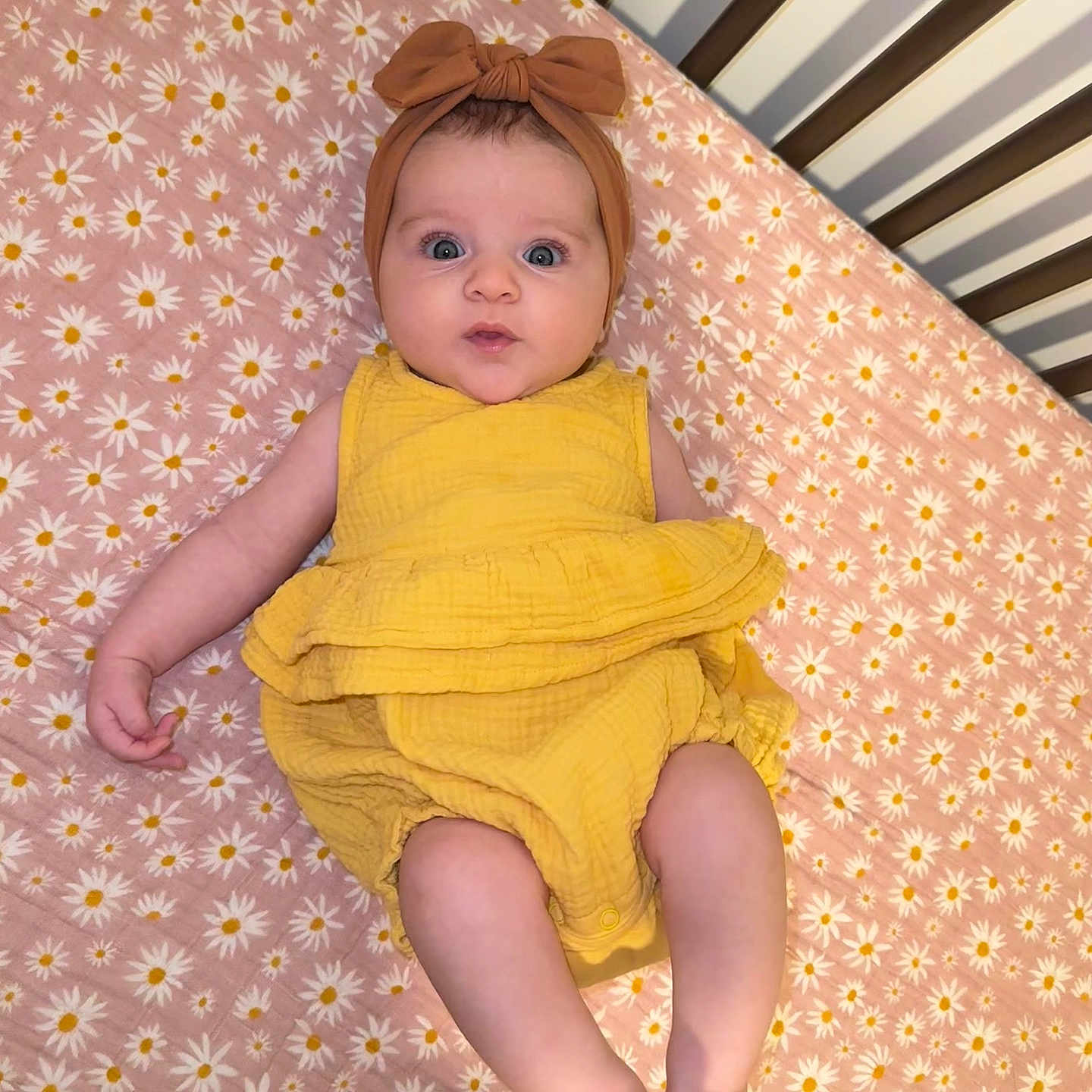 Eleanor is registered to the contest to win money with this photo: baby, bed, blanket, clothing, crib, cushion, dress, face, furniture, hat, head, homedecor, indoors, infantbed, newborn, person, photography, portrait, sitting, sleeve