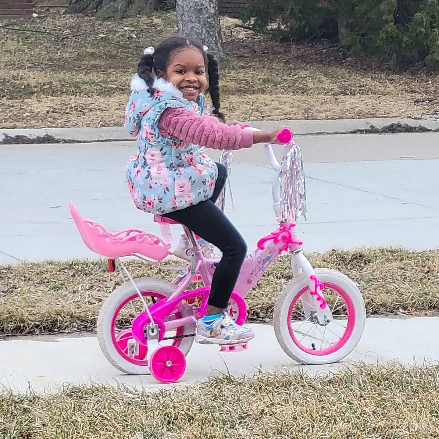 Morgan is registered to the contest to win money with this photo: automotive_tire, automotive_wheel_system, bicycle, bicycle_accessory, bicycle_fork, bicycle_frame, bicycle_handlebar, bicycle_part, bicycle_tire, bicycle_wheel, bicycles_equipment_and_supplies, grass, happy, joy, leisure, person, pink, smile, tire, toddler