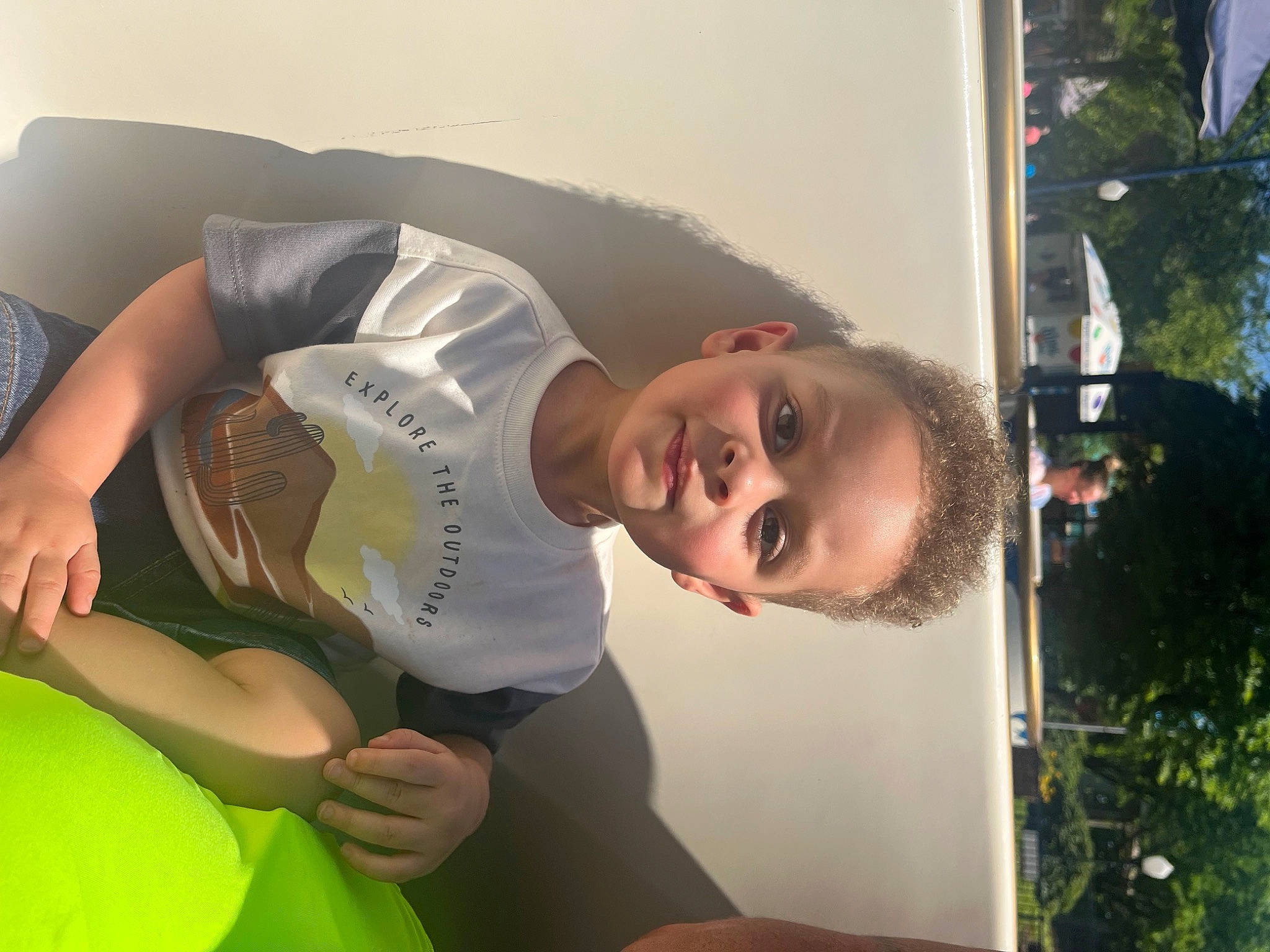 Jaedyn is registered to the contest to win money with this photo: baby, child, comfort, elbow, eyewear, fun, grass, happy, hat, knee, leisure, organism, person, plant, room, sitting, t_shirt, thigh, toddler, tree