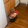 toddler, child, bucket, soapy_water, kitchen, wooden_floor, cabinet, dishwasher, sink, cleaning, bath, indoor, curly_hair, diaper, floor, water, foam, household, playful, fun