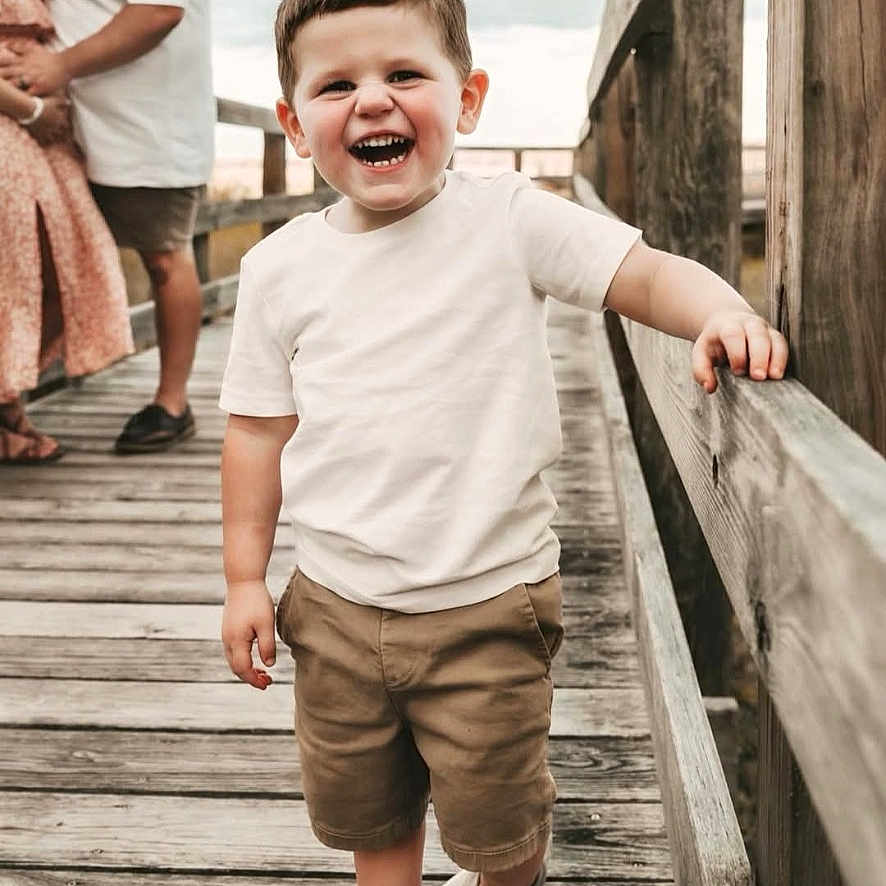 Tate joined the competition — help win amazing prizes! affection, boardwalk, boy, casual_clothing, child, couple, family, happy, love, nature, outdoor, railing, shoes, shorts, sky, smiling, toddler, walking, white_shirt, wooden