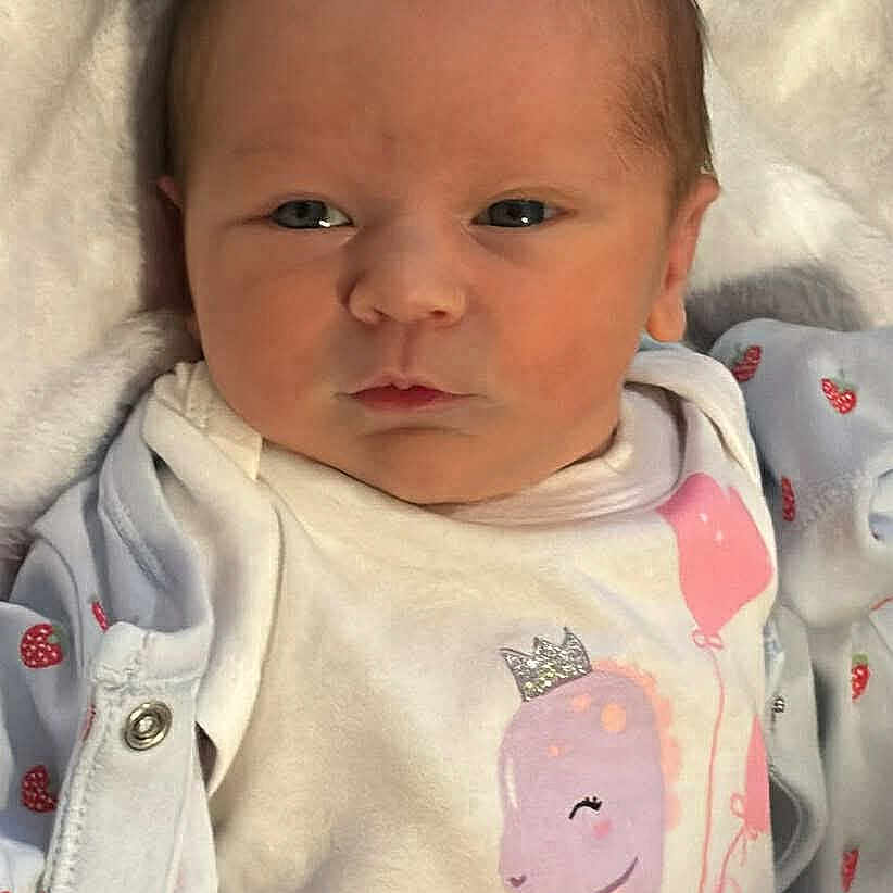 Bella-Leigh joined the competition — help win amazing prizes! baby, blanket, child, closeup, clothing, cute, expression, face, head, human, infant, newborn, onesie, person, pink, portrait, sleepwear, small, soft, white