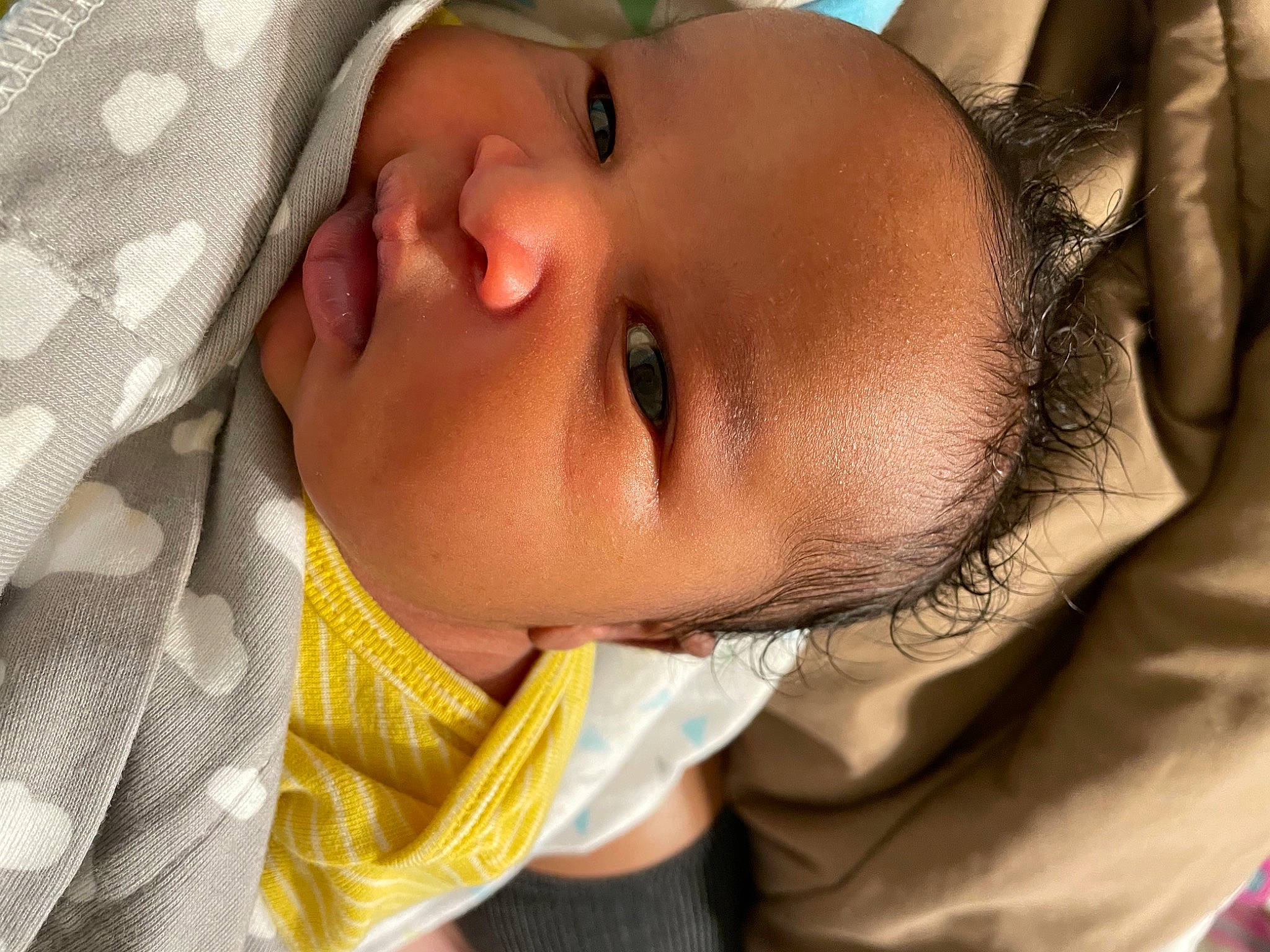 Nathan is registered to the contest to win money with this photo: baby, baby_toddler_clothing, cheek, chin, collar, eye, eyebrow, eyelash, finger, head, human_body, iris, lip, mouth, neck, nose, person, skin, sleeve, smile