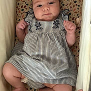 Cataleya participe au concours pour gagner de l'argent avec cette photo : adorable, baby, child, comfort, cute, dress, eyes, face, furniture, hand_ring, hands, indoor, infant, legs, lying_down, patterned_blanket, person, skin, soft, striped