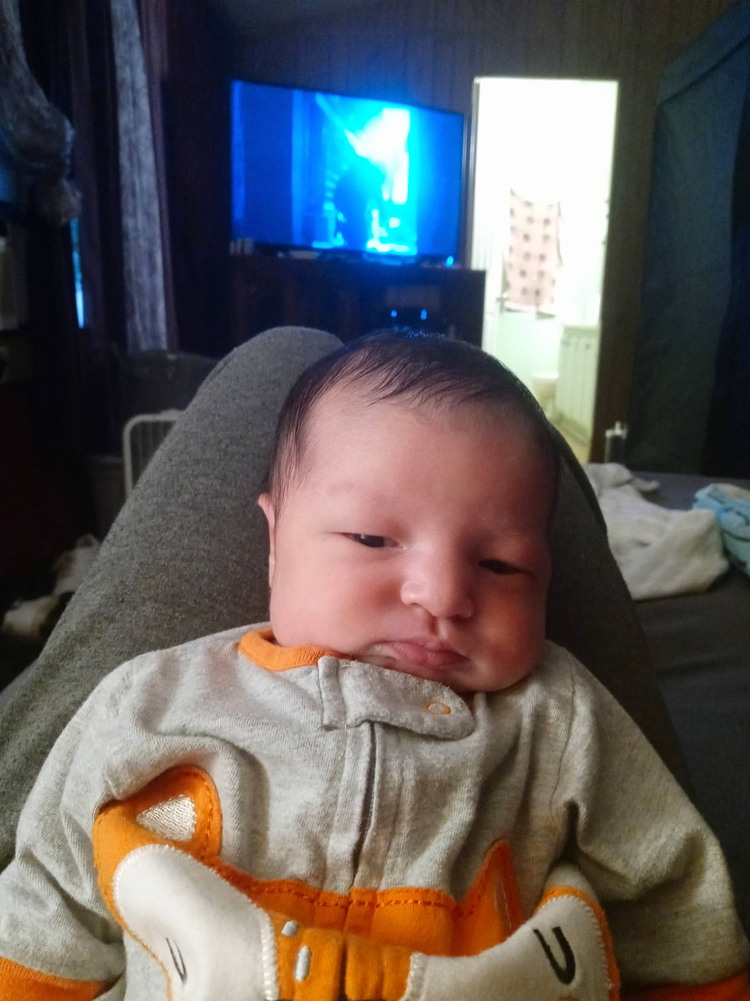 Anthony is registered to the contest to win money with this photo: baby, baby_toddler_clothing, cheek, child, comfort, cool, display_device, eye, eyebrow, fun, gadget, hair, iris, light, nose, person, room, sitting, television, thumb