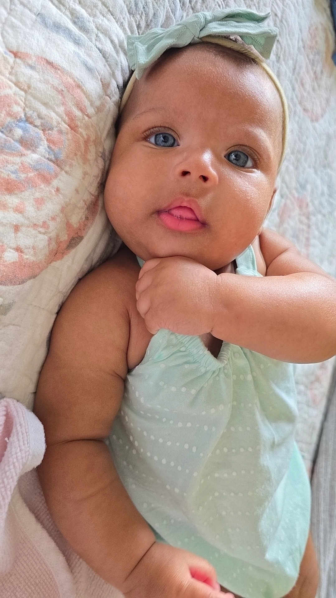 Kalyni is registered to the contest to win money with this photo: baby, infant, child, blue_eyes, headband, mint_green, polka_dot, quilt, close_up, skin, face, hand, cute, adorable, lying_down, soft_light, indoor, portrait, expression, baby_clothes