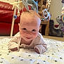 Isabel is registered to the contest to win money with this photo: baby, carpet, child, cozy, cute, face, floor, happy, home, indoors, infant, mobile, person, playful, quilt, red_couch, smiling, soft_toys, star_pattern, wooden_furniture