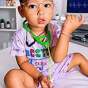 Sk Azan joined the competition — help win amazing prizes! toddler, child, glasses, toy_stethoscope, doctor_set, medical_theme, pajamas, sitting, indoor, medical_chart, teddy_bear, certificate, computer_screen, face, hand, expression, young_child, play, cute, education