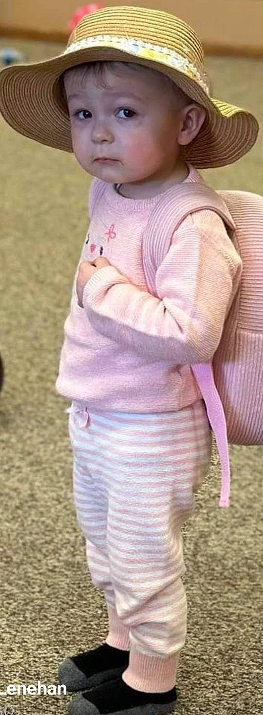 Briella is registered to the contest to win money with this photo: abdomen, baby_toddler_clothing, button, chest, elbow, fashion_accessory, gesture, grass, happy, headwear, human_leg, magenta, pattern, people_in_nature, person, personal_protective_equipment, pink, purple, recreation, sleeve