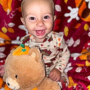 Tobias is registered to the contest to win money with this photo: baby, child, smiling, happy, plush_toy, teddy_bear, halloween, pumpkin, autumn, blanket, cozy, cute, indoors, portrait, infant, cute_clothing, toy, fall_colors, warm, joyful