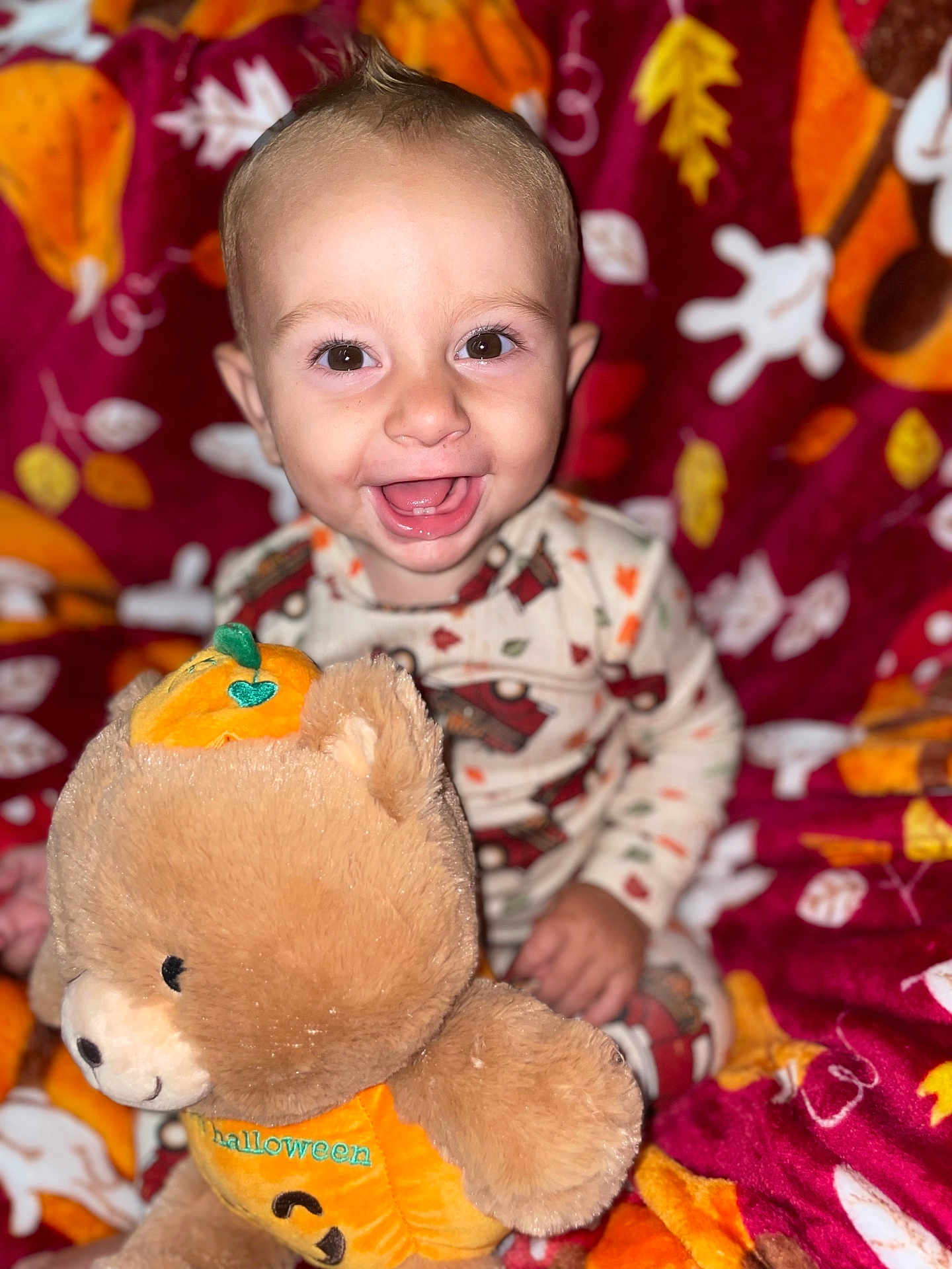 Tobias is registered to the contest to win money with this photo: baby, child, smiling, happy, plush_toy, teddy_bear, halloween, pumpkin, autumn, blanket, cozy, cute, indoors, portrait, infant, cute_clothing, toy, fall_colors, warm, joyful