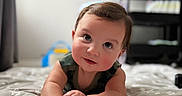Evan is registered to the contest to win money with this photo: baby, infant, child, blanket, star_pattern, curious, smiling, face, indoors, furniture, toy, bedroom, soft_light, crawling, cute, portrait, hands, head, expression, young