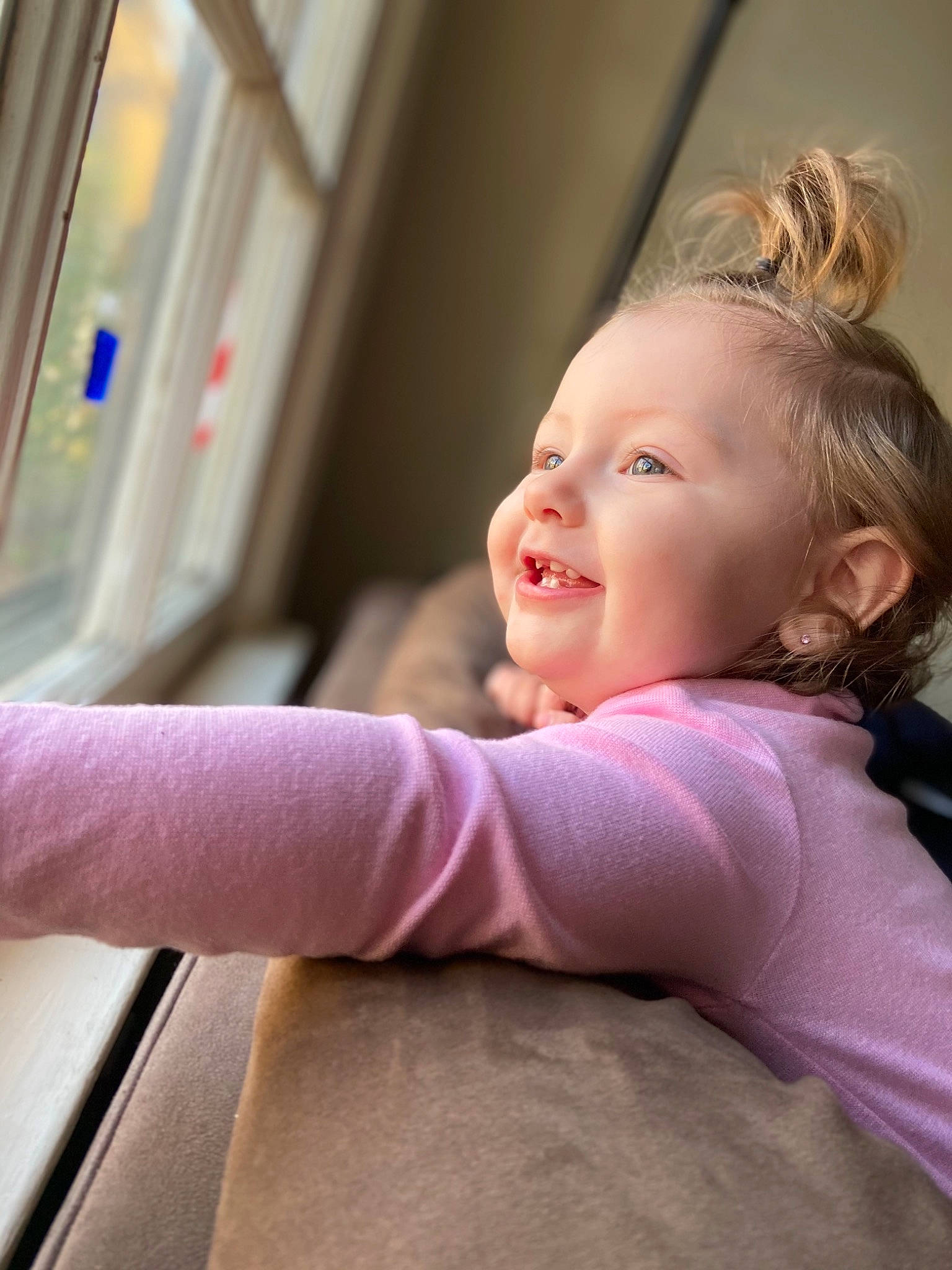 Lillyana is registered to the contest to win money with this photo: baby, blond, comfort, dress, eyebrow, finger, fun, hand, happy, human_body, human_leg, lip, nose, person, shoulder, sitting, skin, smile, toddler, vehicle_door