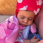 Seyana participe au concours pour gagner de l'argent avec cette photo : baby, sleeping, towel, pink_hat, child, outdoor, sunlight, close_up, peaceful, infant, hand, face, cute, resting, soft_texture, warm_colors, portrait, cozy, young_child, nap