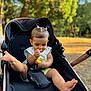 Seyana a rejoint le concours — aidez-le/la à gagner de superbes lots ! baby, child, stroller, outdoor, toy, curly_hair, hair_ties, legs, playful, summer, park, sunlight, infant, cute, seatbelt, casual_clothing, nature, daytime, focus, exploration