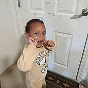 Koda is registered to the contest to win money with this photo: child, toddler, sweatshirt, snoopy, smile, thumbs_up, indoors, door, scribbles, rug, barefoot, person, clothing, floor, carpet, hand_gesture, cute, expression, young_child, wall