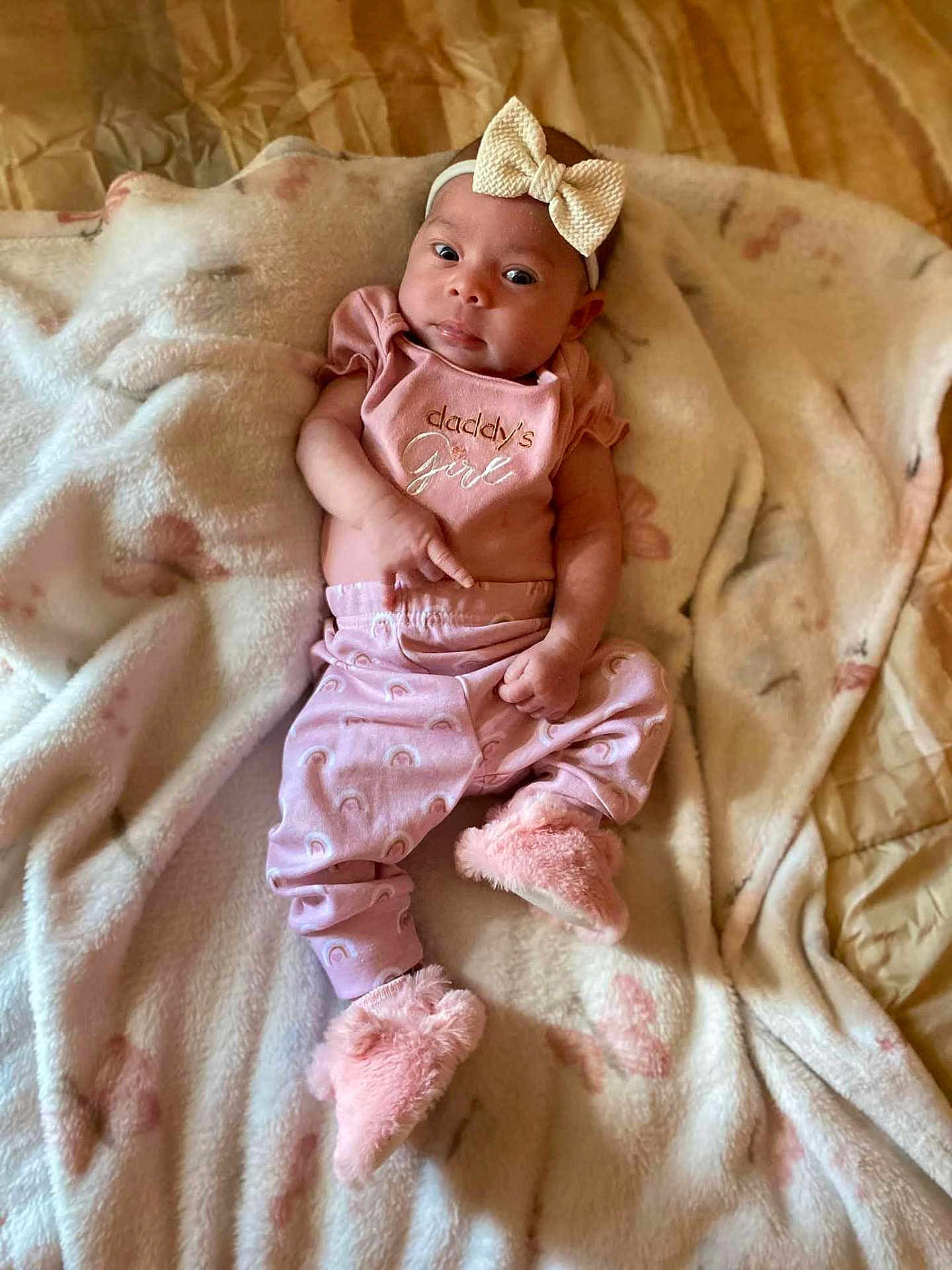 Lucia joined the competition — help win amazing prizes! baby, infant, girl, pink_clothing, headband, bow, blanket, soft_toys, slippers, cute, lying_down, indoors, portrait, child, face, expression, cozy, comfortable, small_hands, small_feet