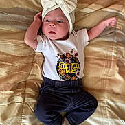 Lucia joined the competition — help win amazing prizes! baby, infant, bow_headband, tshirt, fleetwood_mac, pants, socks, blanket, lying_down, cute, child, young, portrait, indoors, soft_lighting, clothing, apparel, expression, relaxed, small