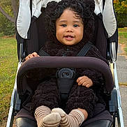 Matteo joined the competition — help win amazing prizes! toddler, child, baby, stroller, portrait, smiling, happy, outdoor, park, autumn, trees, leaves, fleece, jacket, bear_ears, striped_socks, harness, seated, curly_hair, close_up