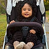 toddler, child, baby, stroller, portrait, smiling, happy, outdoor, park, autumn, trees, leaves, fleece, jacket, bear_ears, striped_socks, harness, seated, curly_hair, close_up