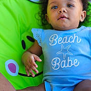 Patiences is registered to the contest to win money with this photo: baby, bodypart, chair, clothing, couch, cushion, face, finger, furniture, hand, happy, head, homedecor, newborn, person, photography, portrait, shorts, sitting, t_shirt