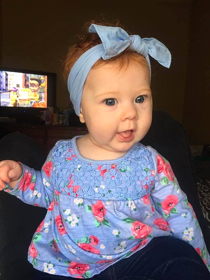 Claudia is registered to the contest to win money with this photo: baby, baby_toddler_clothing, cheek, child, clothing, ear, fashion_accessory, hair_accessory, head, headband, headgear, pattern, person, sleeve, textile, toddler