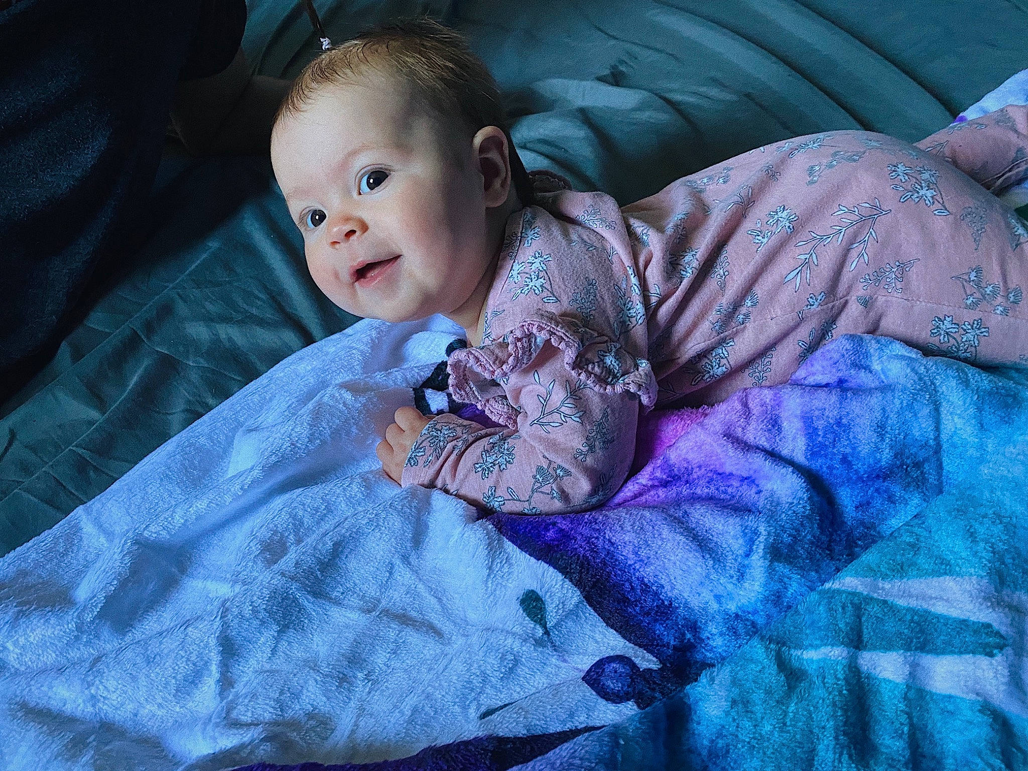 Leilani is registered to the contest to win money with this photo: baby, baby_toddler_clothing, cheek, comfort, electric_blue, eye, face, flash_photography, fun, grass, happy, iris, linens, magenta, person, purple, sitting, sleeve, smile, toddler