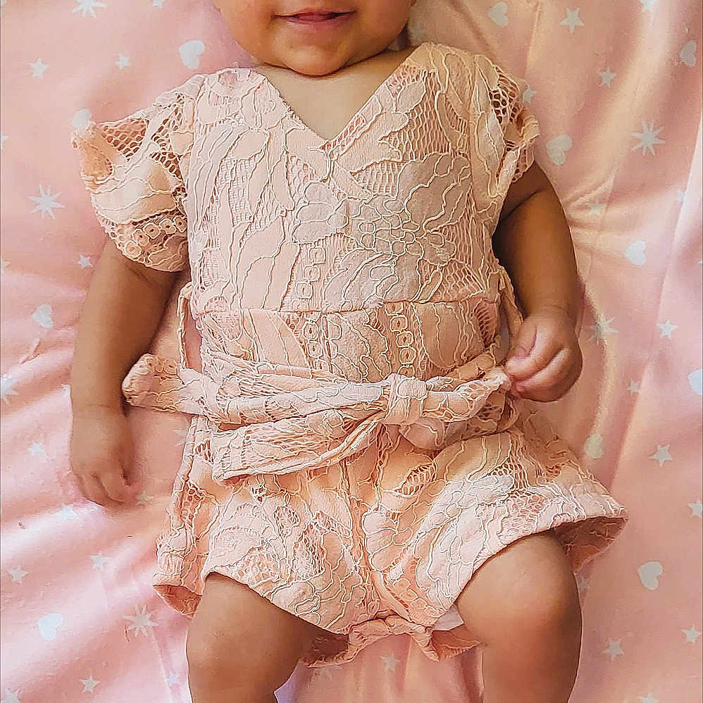 Avianna is registered to the contest to win money with this photo: accessories, baby, bodypart, clothing, dress, face, finger, flower, flowerarrangement, flowerbouquet, formalwear, hand, happy, head, person, photography, portrait, sitting, sleeve, smile