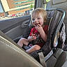 Matthew is registered to the contest to win money with this photo: building, car_interior, car_seat, casual, child, chocolate, daylight, face, hair, hand, happy, messy_face, parking_lot, person, red_shirt, seat, seatbelt, smiling, toddler, window