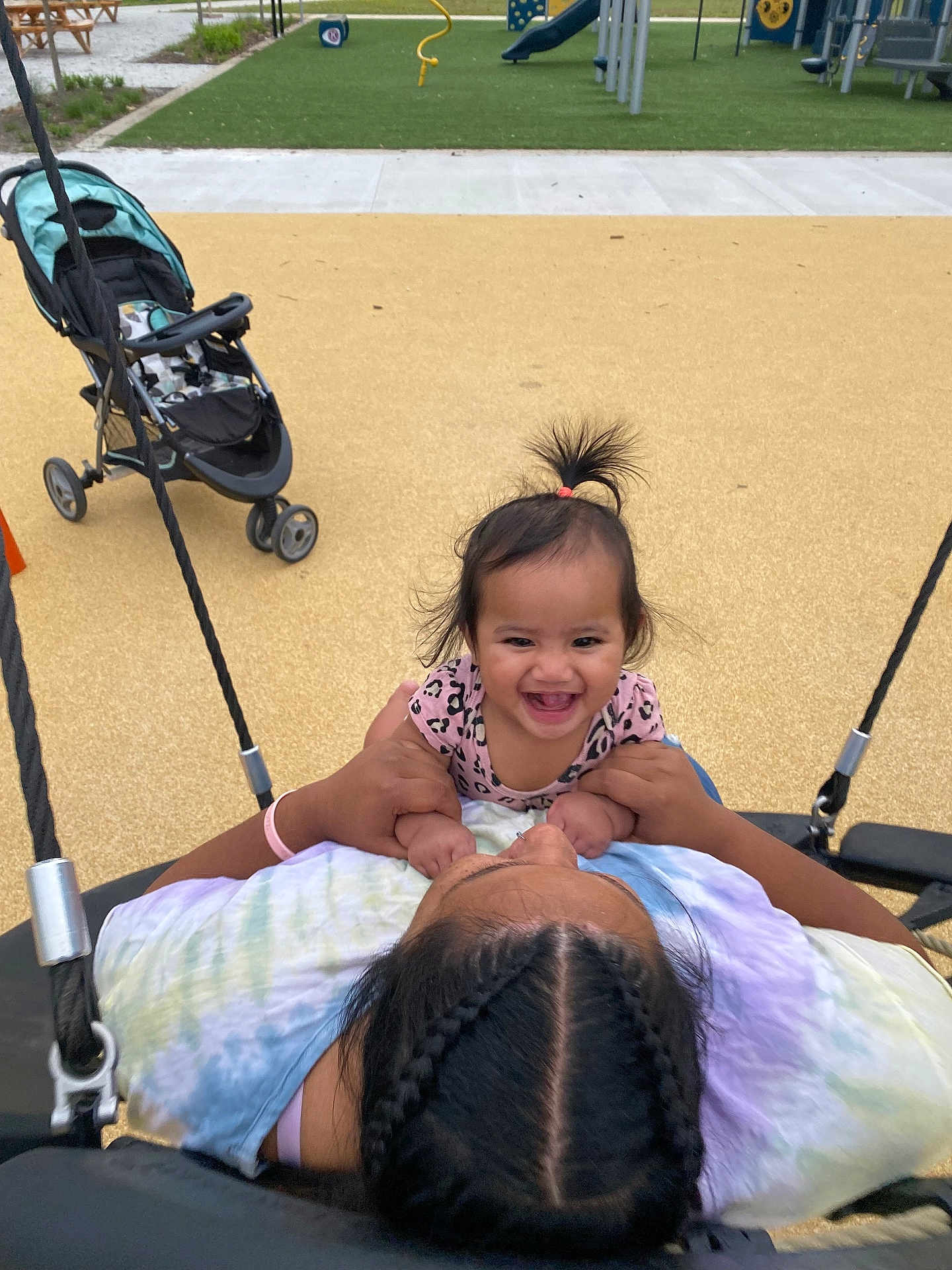 Meilani joined the competition — help win amazing prizes! child, toddler, swing, playground, smiling, happy, person, braided_hair, stroller, outdoor, fun, joy, holding, play, park, casual_clothing, young_child, family, recreation, daylight