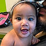 Meilani joined the competition — help win amazing prizes! baby, child, headband, smiling, closeup, face, person, indoor, adult, beard, holding, happy, cute, skin, expression, mouth, eyes, hand, background, clothing