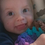 Jasper joined the competition — help win amazing prizes! baby, smiling, crocheted_blanket, blue_clothing, pillow, pattern, umbrella, cloud, happy, child, infant, closeup, face, hand, soft_toys, indoor, portrait, cute, expression, young_child